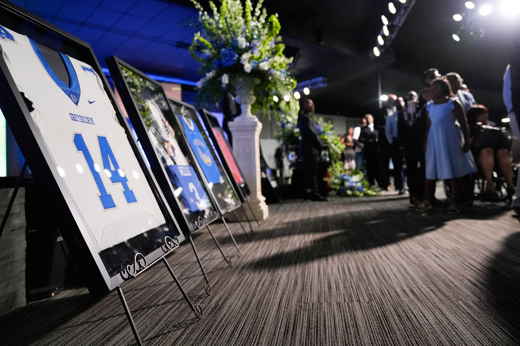 Sports jerseys are framed during a memorial service for Nolan Xavier Wells, an 18-year-old found dead after taking a July 4 boat trip with friends, Monday, July 20, 2026, in Ocean Springs, Miss. (AP Photo/Gerald Herbert)