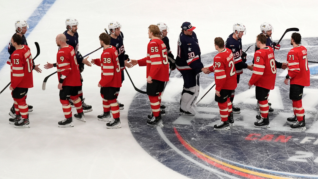 FILE - Canada, bottom, and United States, top, players shake hands following an overtime period of the 4 Nations Face-Off championship hockey game, Feb. 20, 2025, in Boston. (AP Photo/Charles Krupa, File)