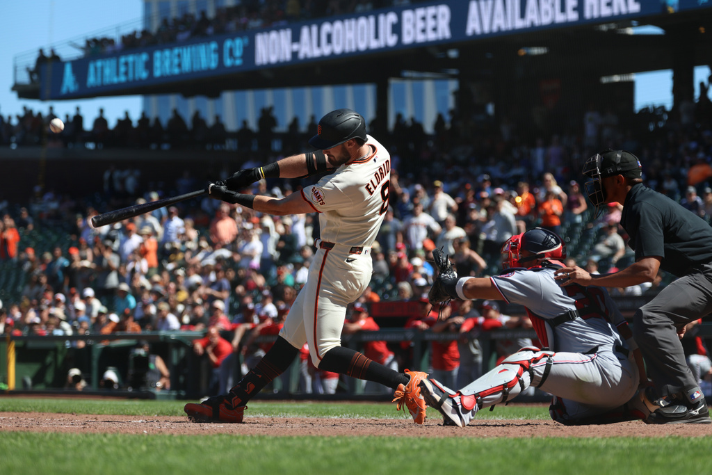 San Francisco Giants' Bryce Eldridge hits a grand slam in front of Washington Nationals catcher Keibert Ruiz during the ninth inning of a baseball game in San Francisco, Wednesday, June 10, 2026. (AP Photo/Jed Jacobsohn)