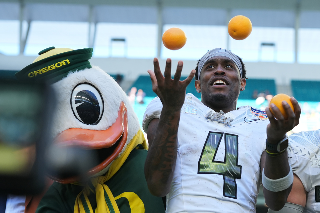Oregon wide receiver Malik Benson (4) juggles oranges after Oregon defeated Texas Tech in the Orange Bowl College Football Playoff quarterfinal game, Thursday, Jan. 1, 2026, in Miami Gardens, Fla. (AP Photo/Lynne Sladky)