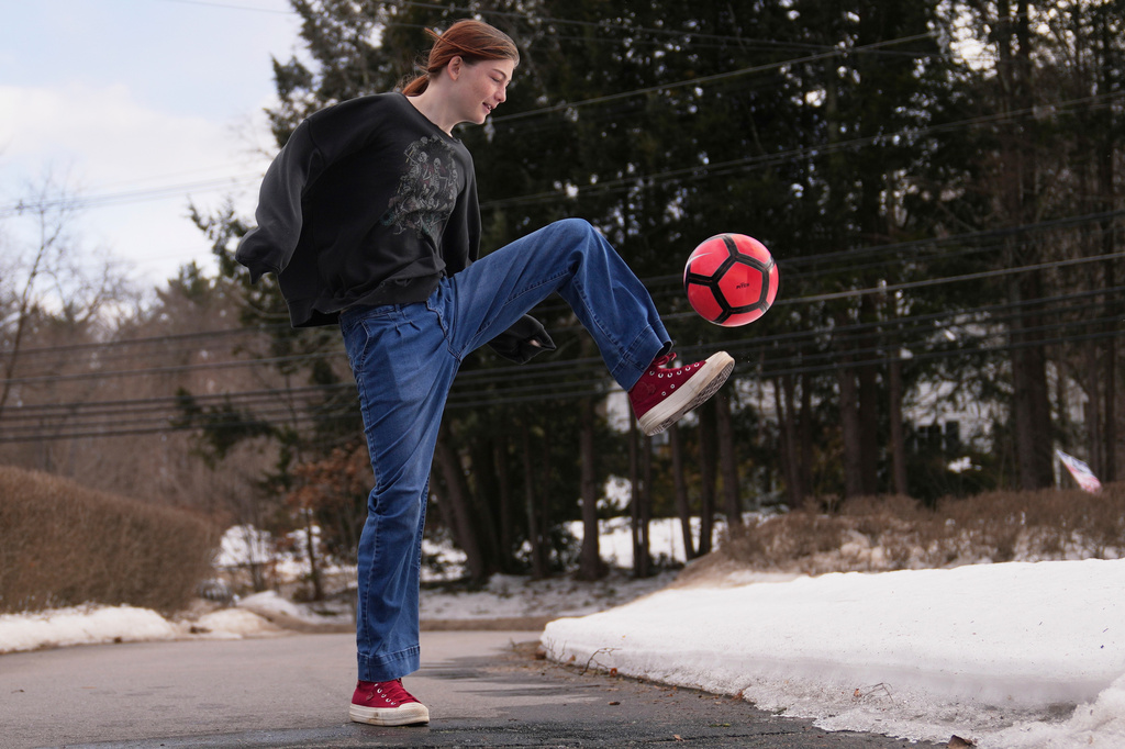 FILE - Parker Tirrell, a transgender athlete who plays on her high school's girls soccer team, practices in the driveway of her family home, Friday, March 7, 2025, in Plymouth, N.H. (AP Photo/Charles Krupa, File)