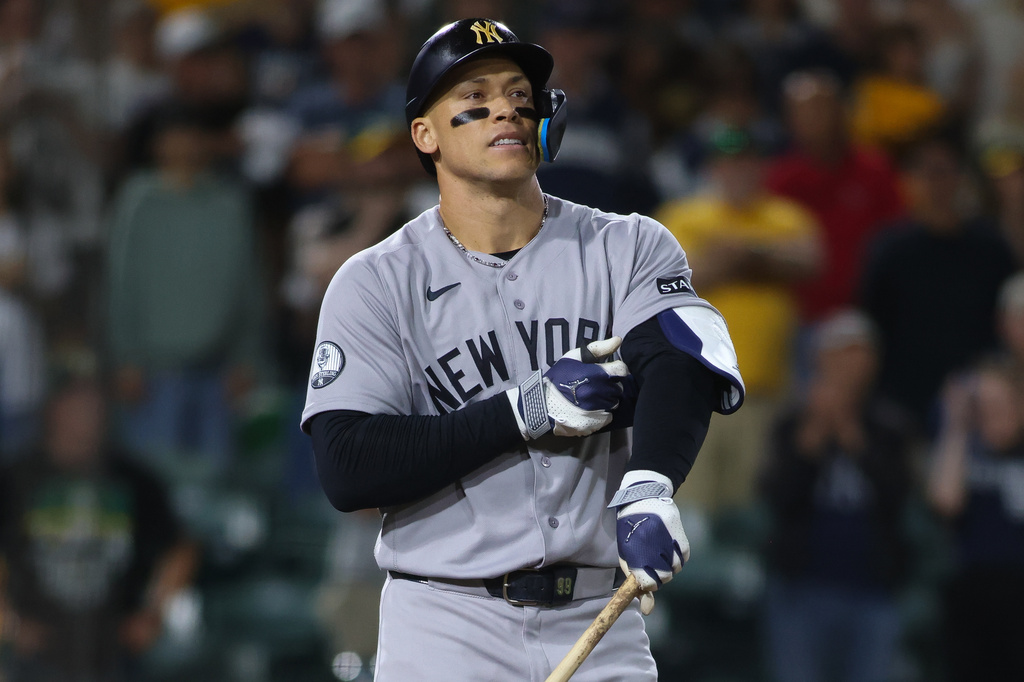 New York Yankees' Aaron Judge reacts after drawing a bases loaded walk to score a run during the ninth inning of a baseball game against the Athletics Saturday, May 30, 2026, in West Sacramento, Calif. (AP Photo/Scott Marshall)