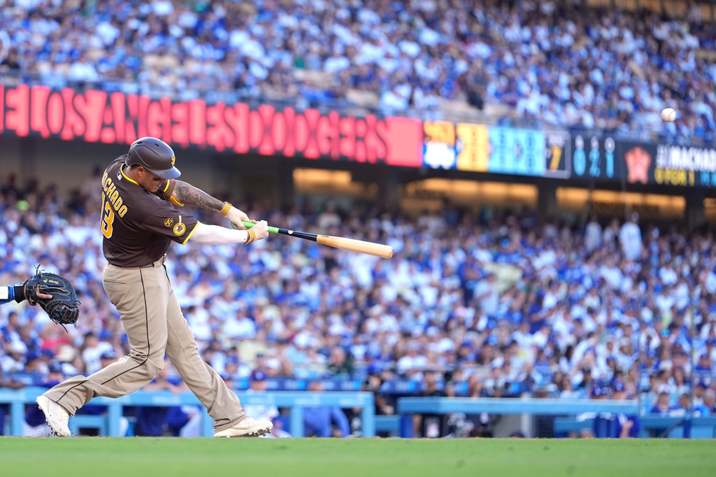 San Diego Padres' Manny Machado hits a three-run home run as during the seventh inning of a baseball game against the Los Angeles Dodgers, Sunday, July 5, 2026, in Los Angeles. (AP Photo/Mark J. Terrill)