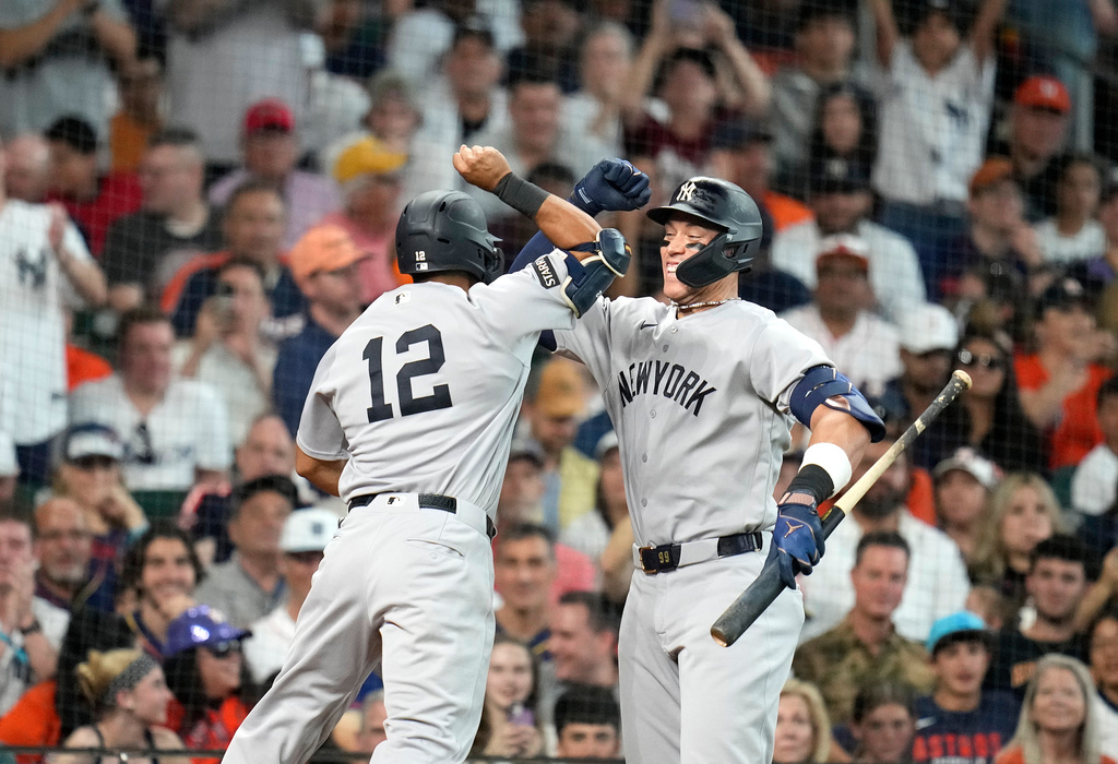 New York Yankees' Trent Grisham (12) celebrates after his home run with Aaron Judge, right, during the third inning of a baseball game against the Houston Astros, Saturday, April 25, 2026, in Houston. (AP Photo/Karen Warren)