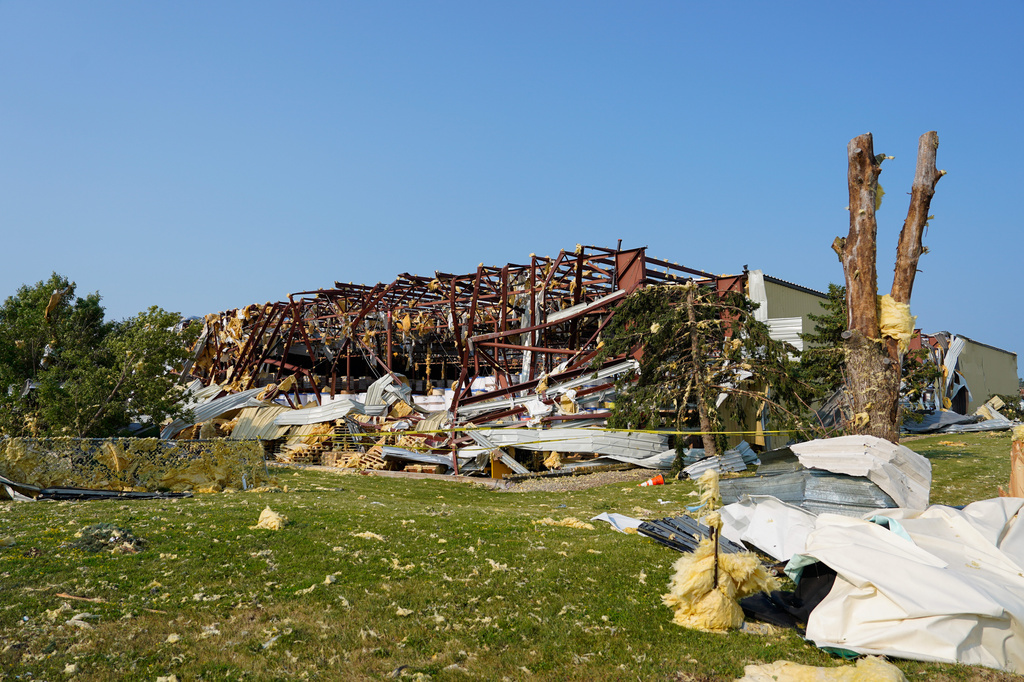 Debris surrounded a damaged warehouse in the aftermath of a tornado that tore through Appleton, Wis., Tuesday, July 28, 2026. (AP Photo/Kayla Wolf)