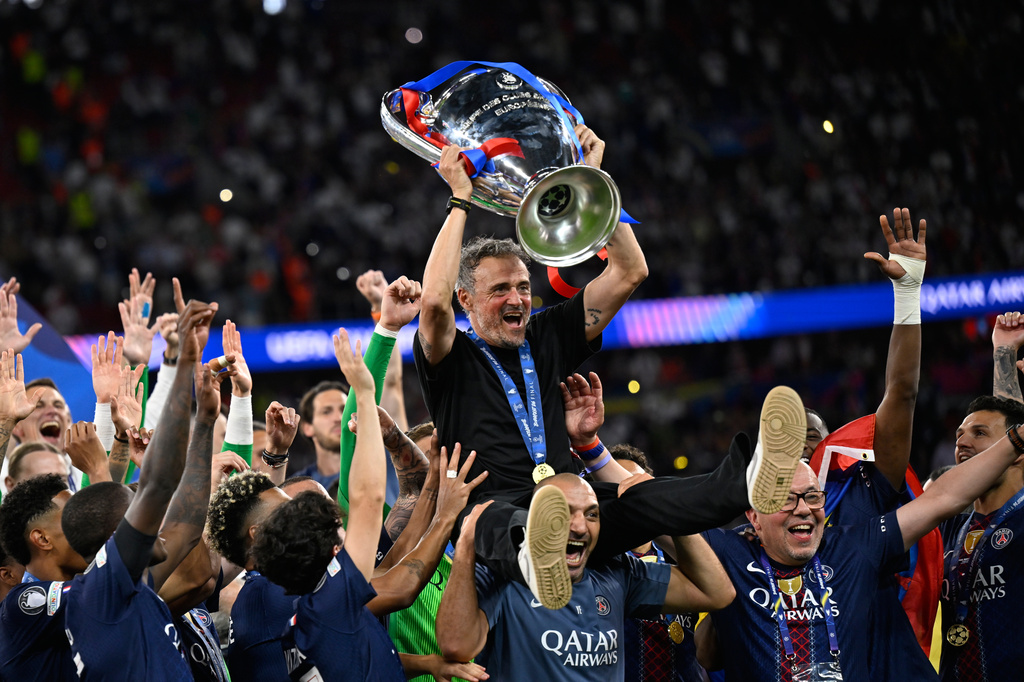 PSG's head coach Luis Enrique, top, celebrates with players after winning the Champions League final soccer match against Arsenal in Budapest, Hungary, Saturday, May 30, 2026. (AP Photo/Denes Erdos)
