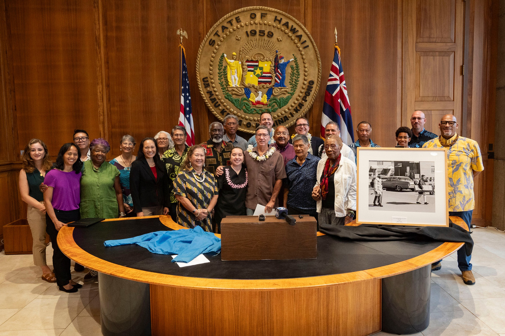 Acting Hawaiʻi Lieutenant Governor Keith Regan, State Archivist Adam Jansen, and Steven Springel join community partners and invited guests for a group photo at the opening of a historic civil rights photography exhibit at the Hawaii State Capitol, Tuesday, June 30, 2026, in Honolulu. (AP Photo/Mengshin Lin)