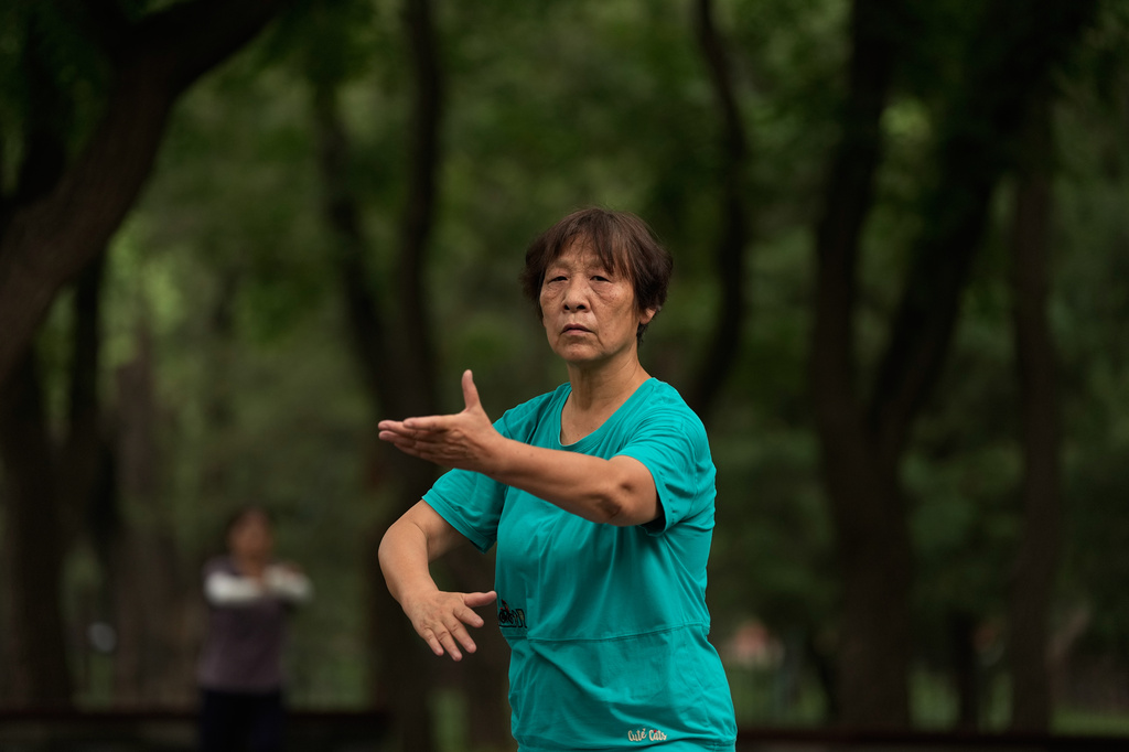 A woman practices Tai Chi at a park near the Temple of Heaven in Beijing, Thursday July 9, 2026. (AP Photo/Andy Wong)