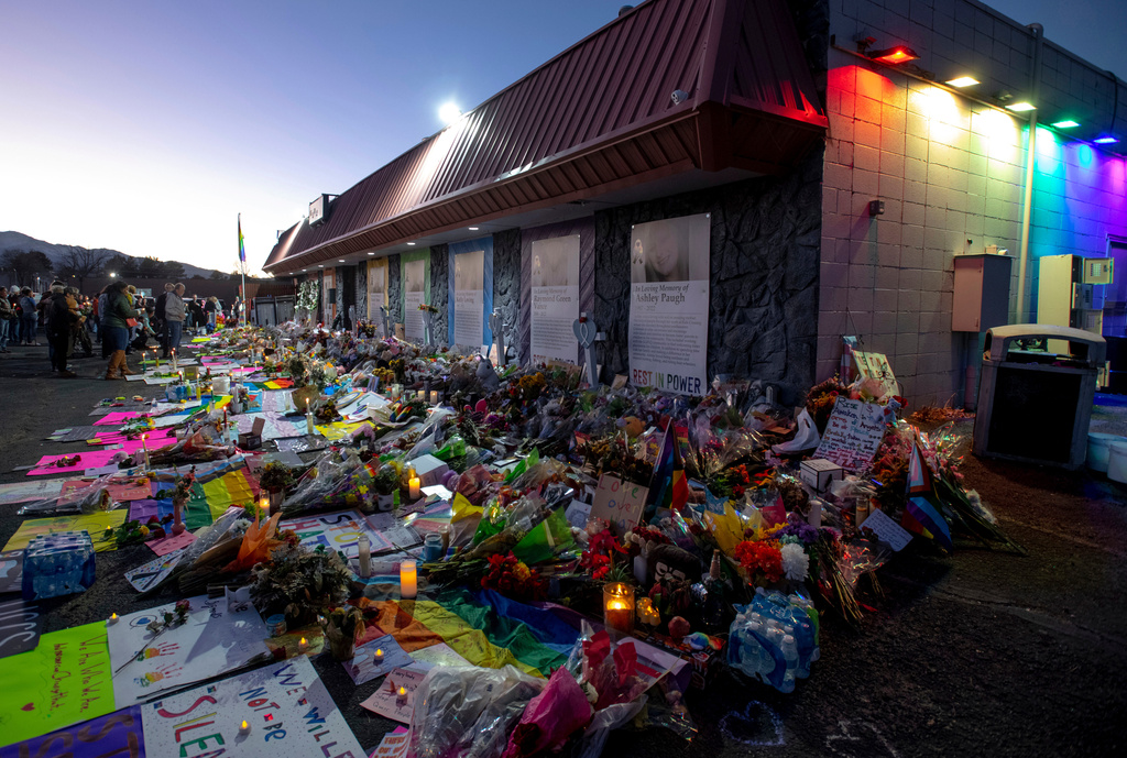 FILE - Mourners gather outside Club Q to visit a memorial on Nov. 25, 2022, in Colorado Spring, Colo. (Parker Seibold/The Gazette via AP, File)