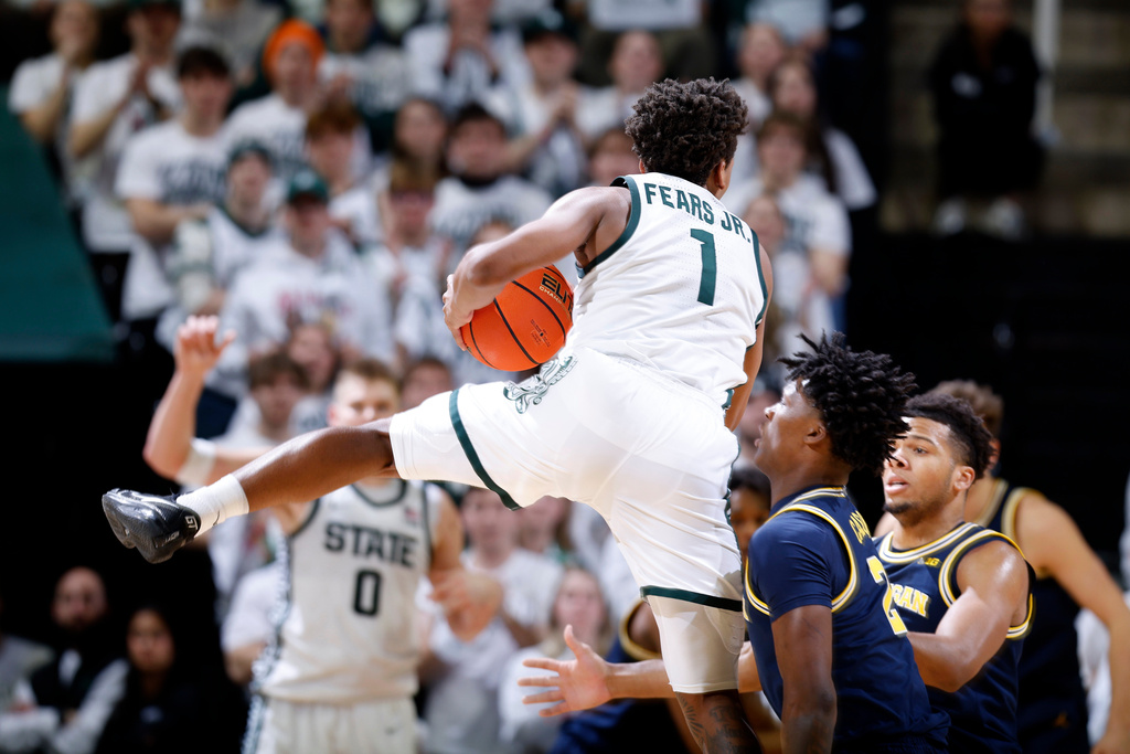 Michigan State guard Jeremy Fears Jr. (1) and Michigan guard L.J. Cason (2) vie for the ball during the first half of an NCAA college basketball game, Friday, Jan. 30, 2026, in East Lansing, Mich. (AP Photo/Al Goldis)