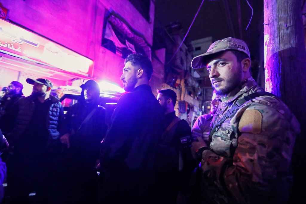 Syrian security forces secure the area around a building that, according to state media, was hit by rockets Friday, Nov. 14, 2025. It was not immediately clear who was behind the attack. (AP Photo/Omar Sanadiki)