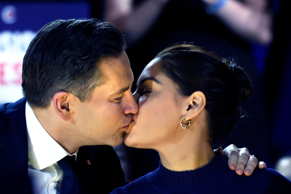 Conservative Party Leader Pierre Poilievre and wife Anaida kiss as they arrive at the podium at the party's national convention in Calgary, Friday, Jan. 30, 2026. (Larry MacDougal /The Canadian Press via AP)