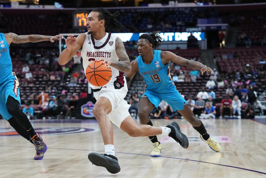 Massachusetts guard Marcus Banks Jr. drives to the basket during the second half of an NCAA college basketball game against Florida State at the Orange Bowl Basketball Classic, Saturday, Dec. 13, 2025, in Sunrise, Fla. (AP Photo/Lynne Sladky)