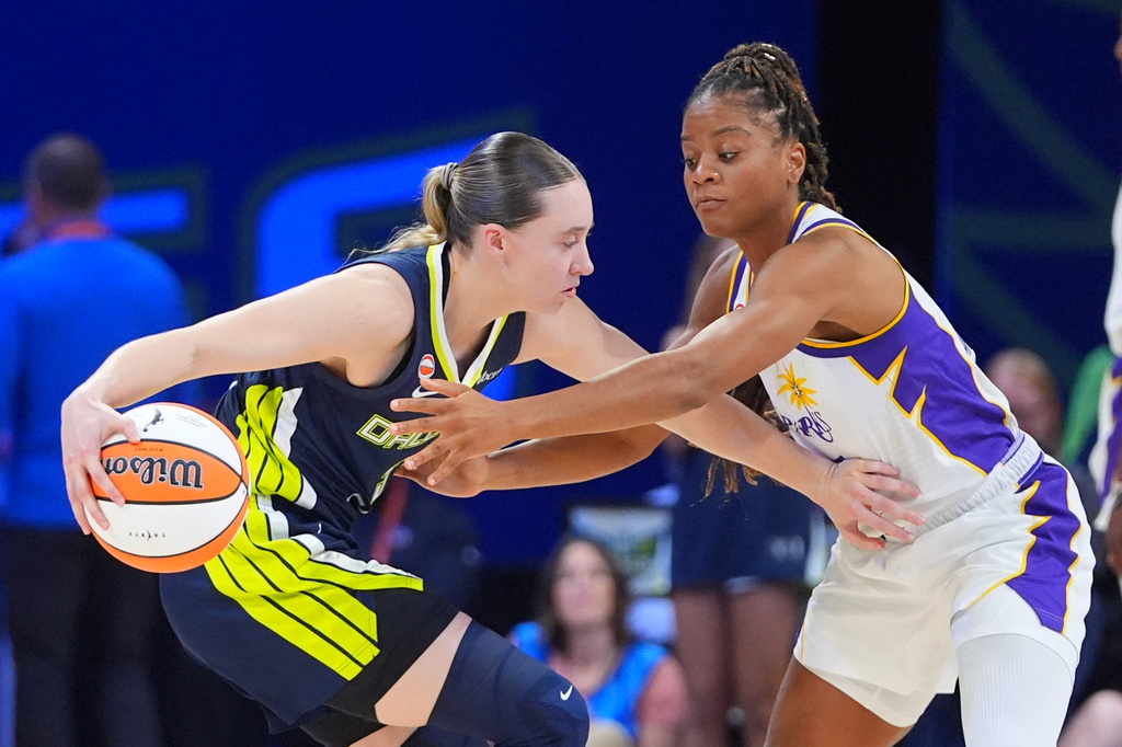 Dallas Wings guard Paige Bueckers, left, keeps the ball from Los Angeles Sparks forward Sania Feagin (1) during the first half of a WNBA basketball game in Arlington, Texas, Thursday, Sept. 17, 2026. (AP Photo/LM Otero)