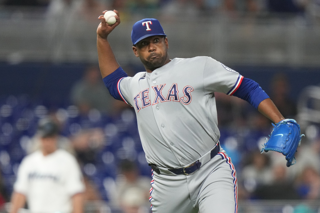 Texas Rangers relief pitcher Kumar Rocker throws out Miami Marlins' Griffin Conine at first during the fifth inning of a baseball game, Monday, June 22, 2026, in Miami. (AP Photo/Lynne Sladky)