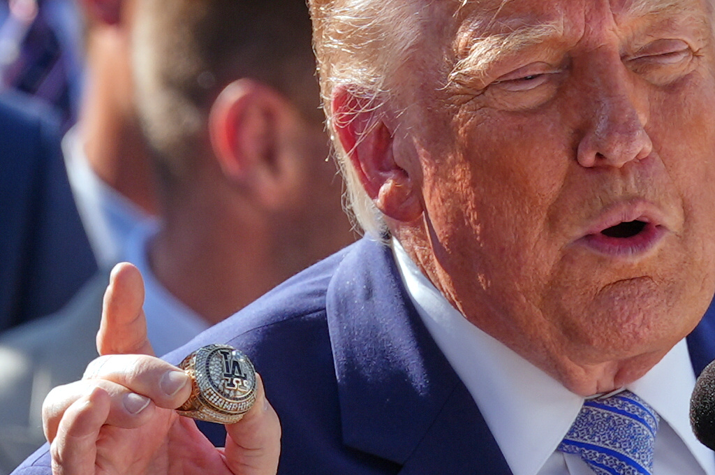 President Donald Trump holds a LA Dodgers Championship Ring during an event to honor the 2025 World Series champions Los Angeles Dodgers in the Rose Garden of the White House, Thursday, July 23, 2026, in Washington. (AP Photo/Julia Demaree Nikhinson)