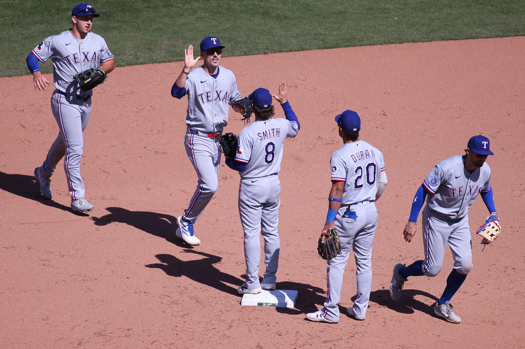 The Texas Rangers celebrates after their victory over the Athletics in a baseball game Thursday, April 16, 2026, in West Sacramento, Calif. (AP Photo/Scott Marshall)