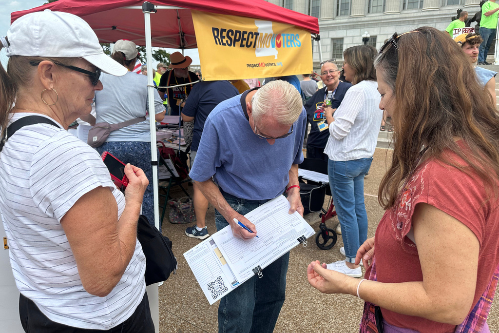 John Billman, of Columbia, Missouri, signs a petition for a proposed constitutional amendment limiting the Legislature's ability to revise voter-approved, citizen-initiated ballot measures on Wednesday, Sept. 10, 2025, at the state Capitol in Jefferson City, Mo. (AP Photos/David A. Lieb)