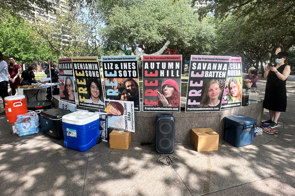 Supporters of protesters convicted over a shooting outside a Texas immigration detention center display signs in support of the defendants outside a federal courthouse in Fort Worth, Texas on Tuesday, June 23, 2026. (AP Photo/Kendria LaFleur)
