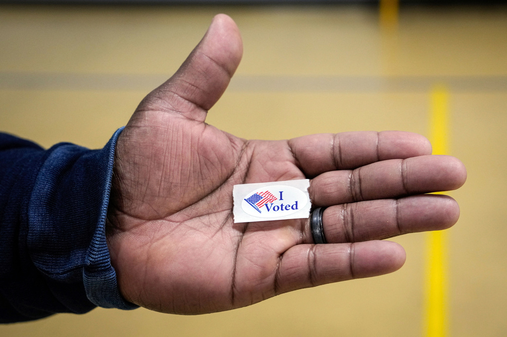 FILE - Sasha Dix holds his, "I voted," sticker after voting at T.C. Roberson High School on Election Day, Nov. 5, 2024, in Asheville, N.C. (AP Photo/Kathy Kmonicek, File)