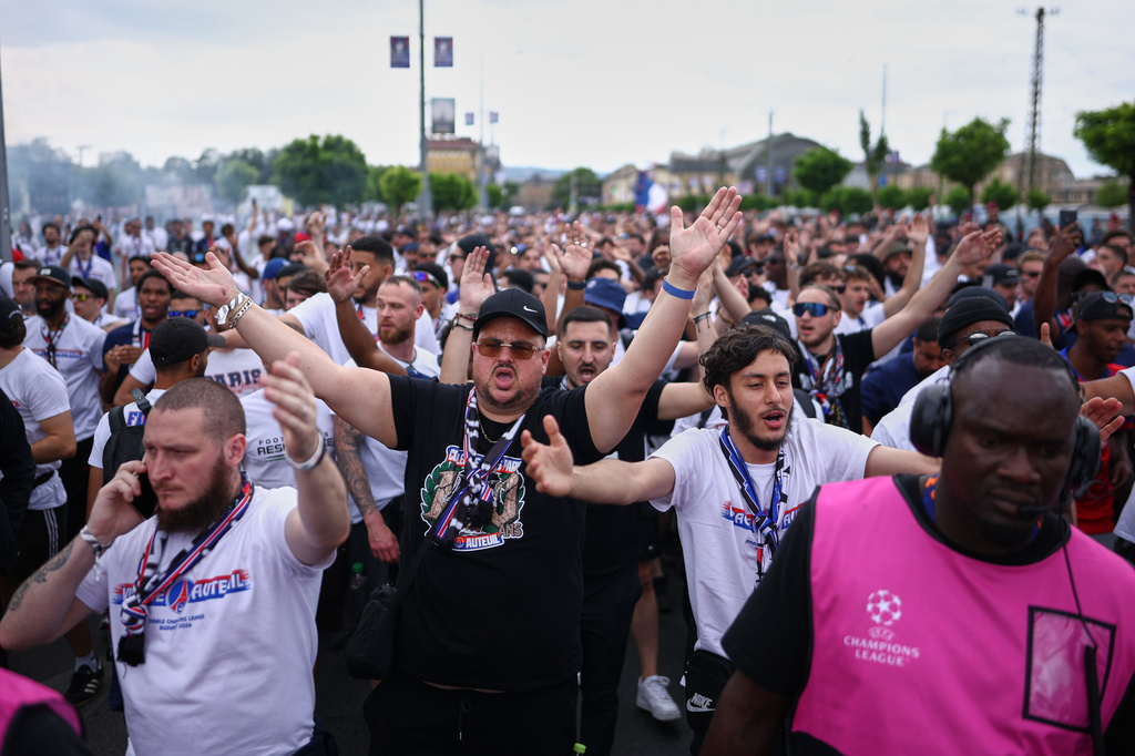 PSG supporters are accompanied by security ahead of the Champions League final soccer match between Paris Saint-Germain and Arsenal in Budapest, Hungary, Saturday, May 30, 2026. (AP Photo/Rudolf Karancsi-Albert)