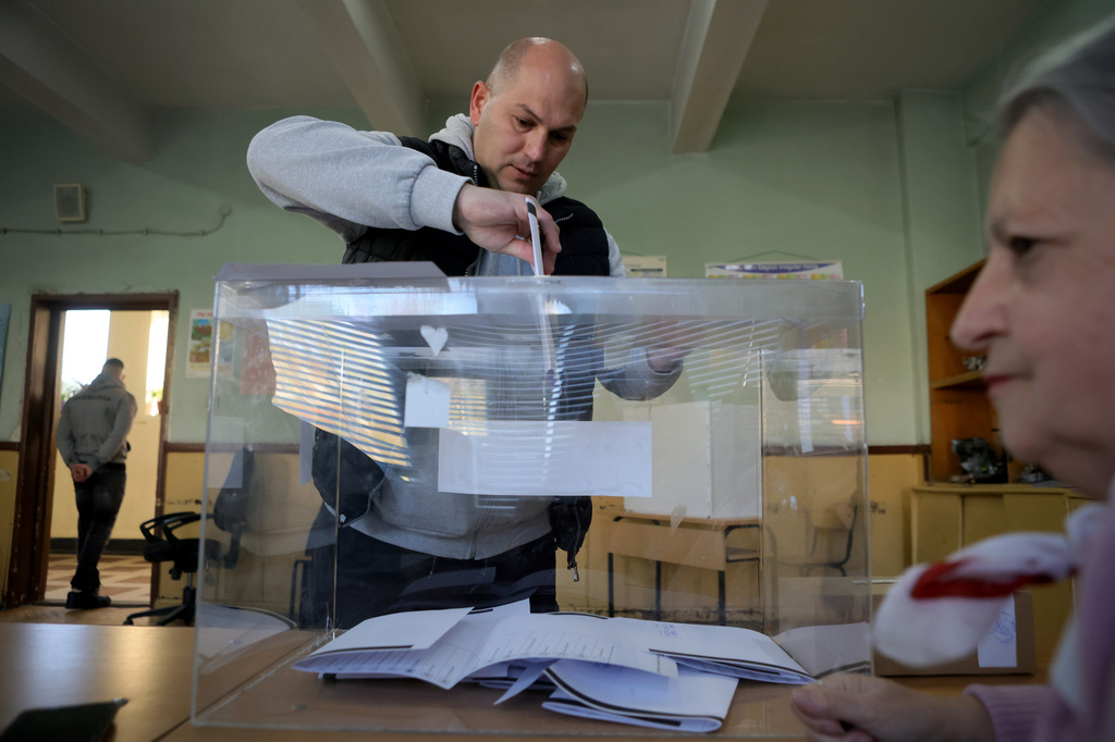 A man casts his ballot during an early election at a polling station in Sofia on Sunday, April 19, 2026. (AP Photo/Valentina Petrova)