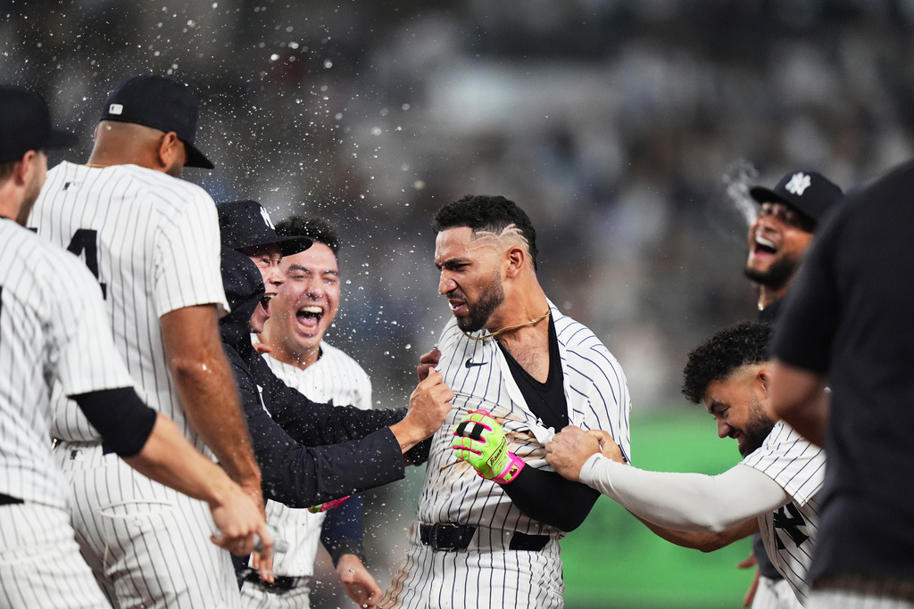 New York Yankees' Trent Grisham celebrates with teammates after hitting a walk-off RBI single during the ninth inning of a baseball game against the Chicago White Sox Tuesday, Sept. 23, 2025, in New York. (AP Photo/Frank Franklin II)