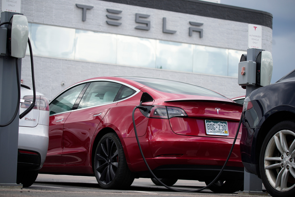 FILE - A 2021 Model 3 sedan sits in a near-empty lot at a Tesla dealership in Littleton, Colo. June 27, 2021. (AP Photo/David Zalubowski, File)