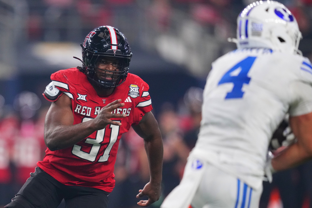 Texas Tech linebacker David Bailey (31) gives chase as BYU running back LJ Martin (4) runs the ball in the second half of a Big 12 Conference championship NCAA college football game Saturday, Dec. 6, 2025, in Arlington, Texas. (AP Photo/Julio Cortez)