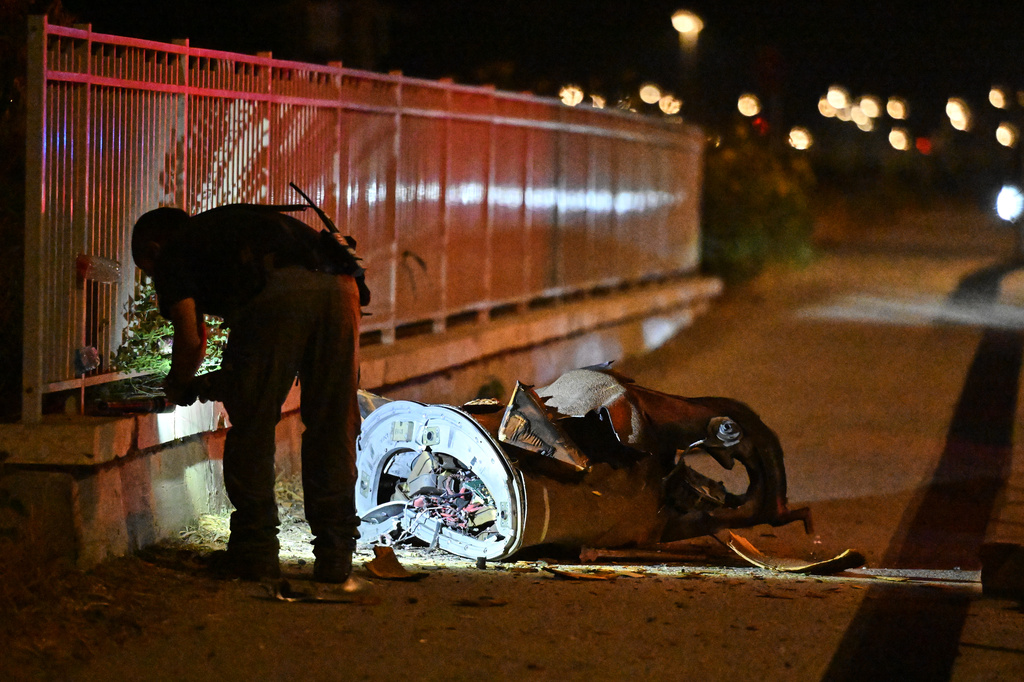Israeli security forces examine a fragment of an intercepted Iranian missile in northern Israel, early Monday, June 8, 2026. (AP Photo/Rami Shlush)