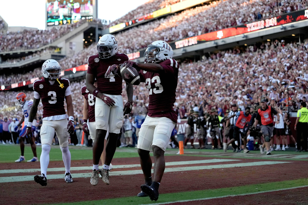 Texas A&M running back Jamarion Morrow (23) reacts after scoring a touchdown against Florida during the first half of an NCAA college football game Saturday, Oct. 11, 2025, in College Station, Texas. (AP Photo/Sam Craft)
