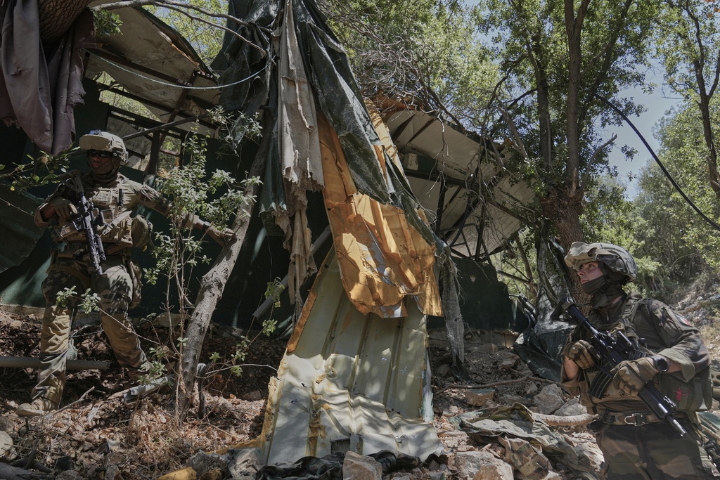 A French U.N. peacekeeper examines a destroyed position Hezbollah in the Saluki Valley, southern Lebanon, Wednesday, Aug. 20, 2025. (AP Photo/Hussein Malla)