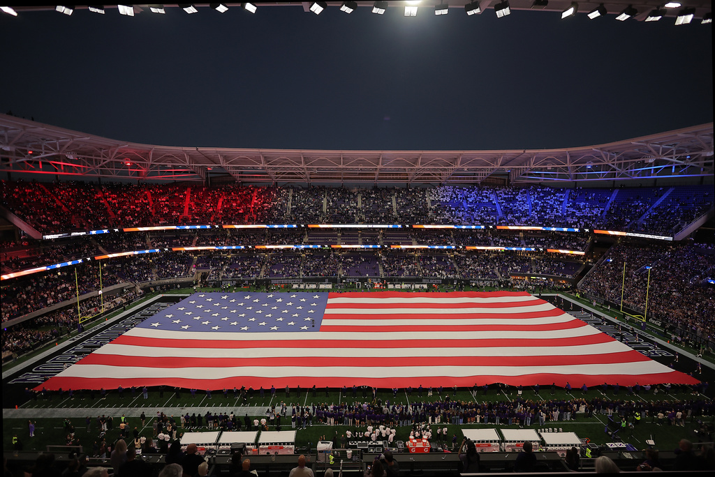 A Unites States flag is held over the new Ryan Field during the national anthem before an NCAA college football game between Penn State and Northwestern in Evanston, Ill., Friday, Oct. 2, 2026. (AP Photo/Melissa Tamez)
