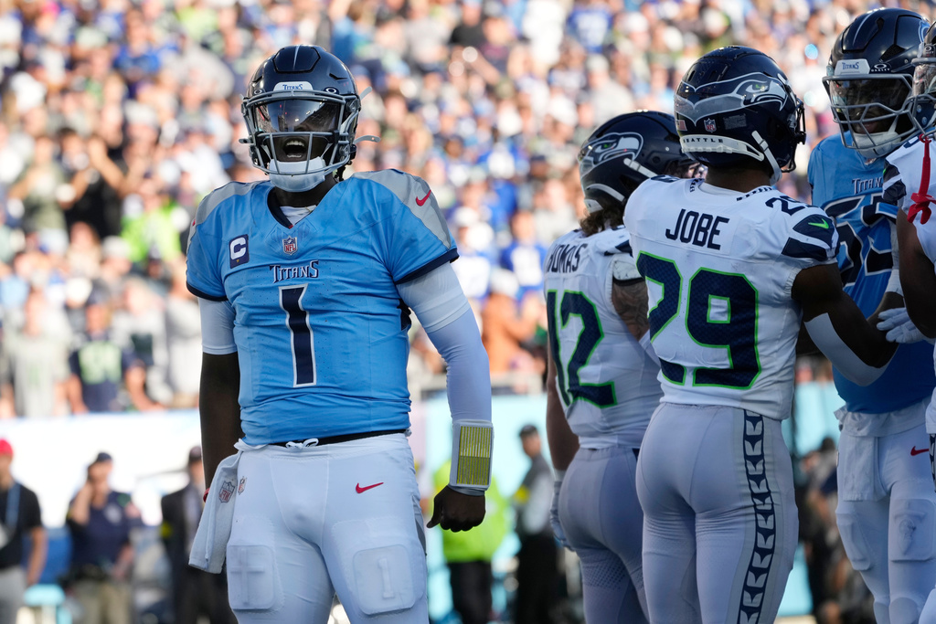 Tennessee Titans quarterback Cam Ward (1) celebrates after scoring a touchdown against the Seattle Seahawks during the second half of an NFL football game Sunday, Nov. 23, 2025, in Nashville, Tenn. (AP Photo/George Walker IV)