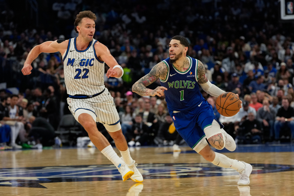 Minnesota Timberwolves guard LaMelo Ball (1) drives past Orlando Magic forward Franz Wagner (22) during the second half of an NBA basketball game, Friday, Oct. 23, 2026, in Orlando, Fla. (AP Photo/John Raoux)