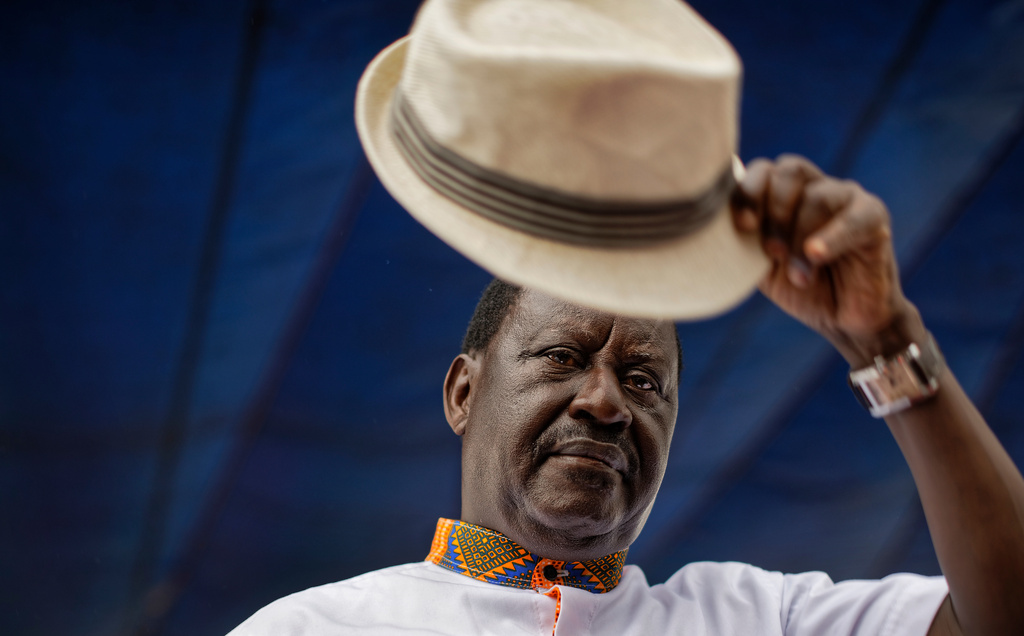 Kenyan opposition leader Raila Odinga lifts his hat to thousands of supporters gathered at a rally in the Shauri Moyo area of Nairobi, Kenya, Wednesday, Oct. 18, 2017. (AP Photo/Ben Curtis)