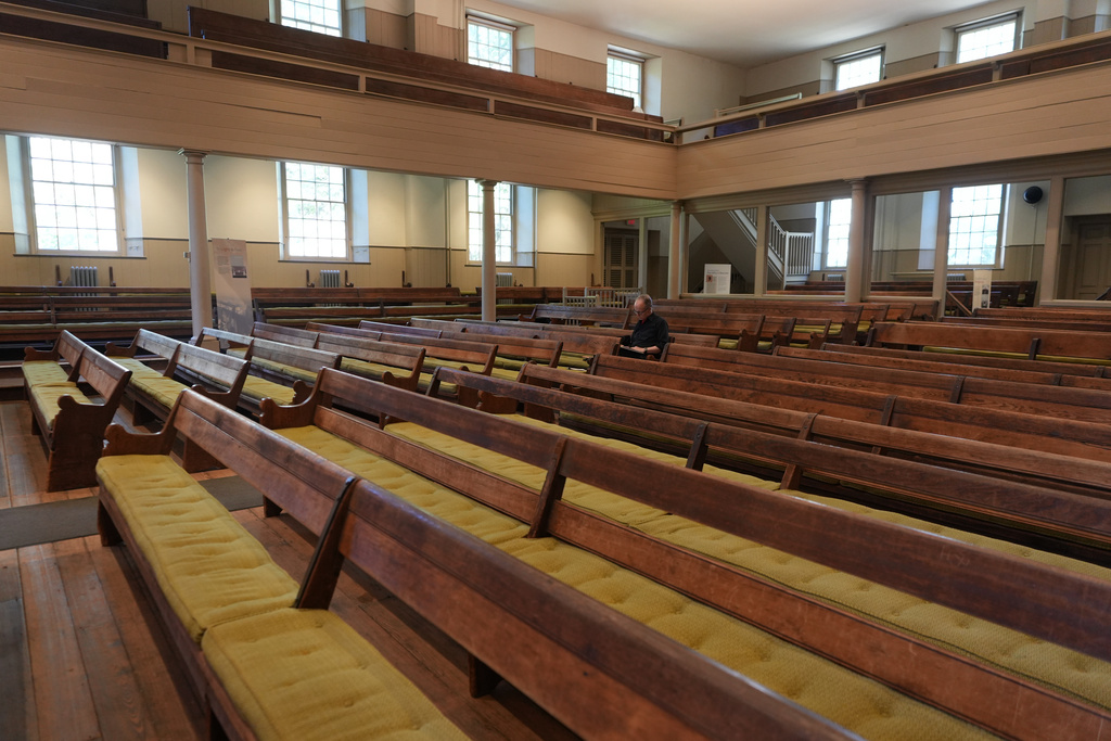 Jeffrey Kippax sits alone as he reads a text in preparation for upcoming Sunday worship in the historic West Room of the Arch Street Meeting House in Philadelphia on Oct. 5, 2025. (AP Photo/Luis Andres Henao)