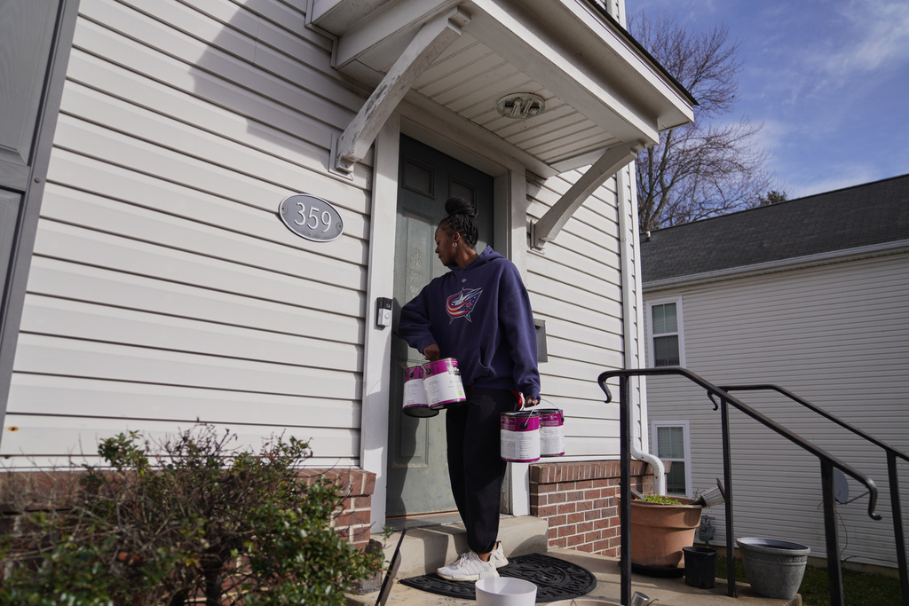 A group from the Neighborhood Resilience Project, an Orthodox social service agency connected to St. Moses the Black Orthodox Church, paints a home in Clairton, Pa., as part of the organization's community-building programs, Monday, Nov. 24, 2025. (AP Photo/Jessie Wardarski)