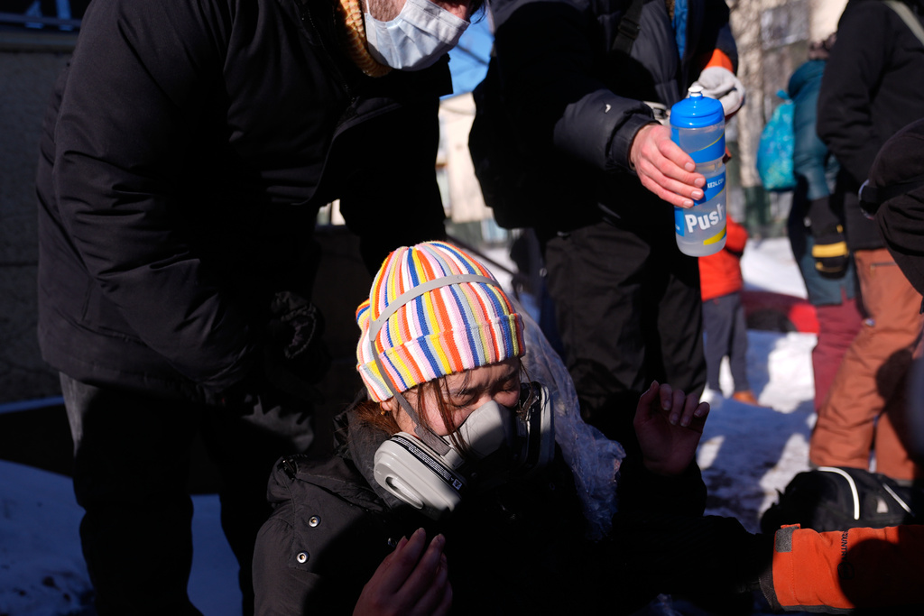A person is tended to after federal immigration officers deploy tear gas Saturday, Jan. 24, 2026, in Minneapolis. (AP Photo/Abbie Parr)
