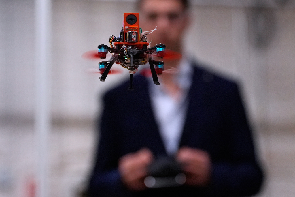Colin Balfour, a sophomore studying robotics engineering, flies a small drone at a laboratory at the Worcester Polytechnic Institute, Monday, Oct. 20, 2025, in Worcester, Mass. (AP Photo/Charles Krupa)