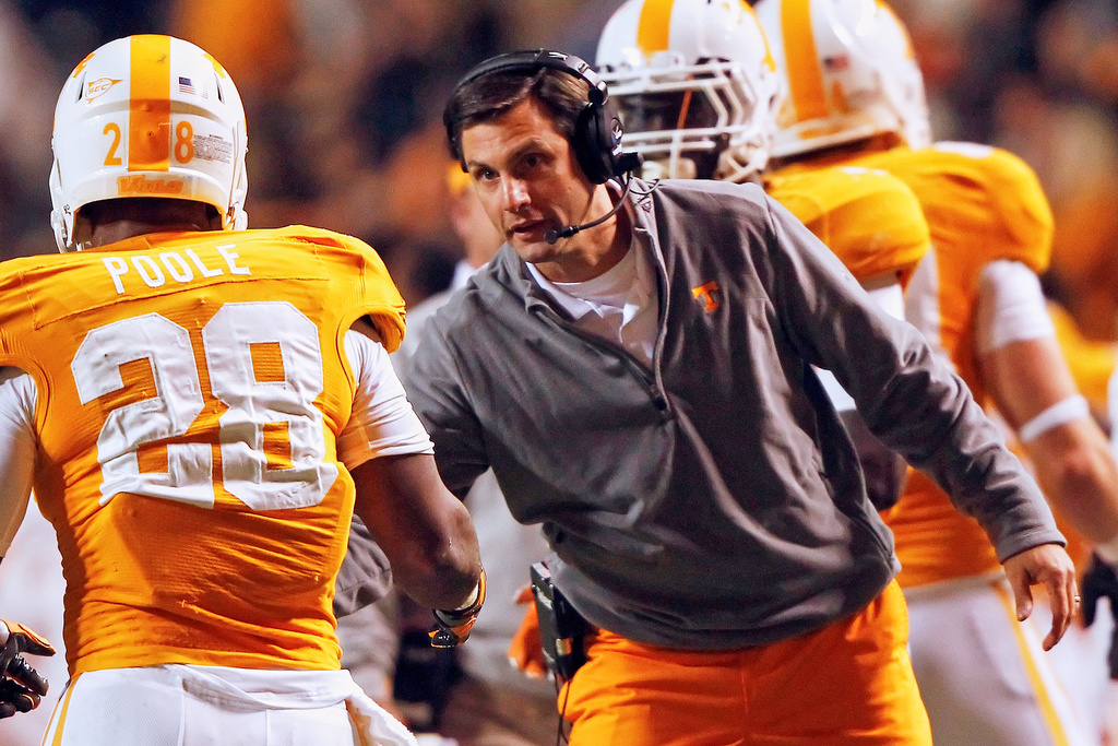FILE - Tennessee head coach Derek Dooley, right, congratulates Tauren Poole (28) after he scored in the first quarter of an NCAA college football game against Middle Tennessee, Nov. 5, 2011, in Knoxville, Tenn. (AP Photo/Wade Payne, File)