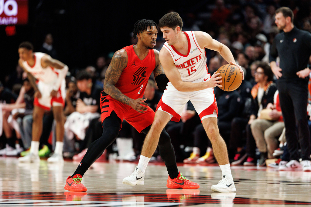 Houston Rockets guard Reed Sheppard, right, keeps the ball from Portland Trail Blazers guard Caleb Love, left, during the first half of an NBA basketball game Friday, Jan. 9, 2026, in Portland, Ore. (AP Photo/Howard Lao)