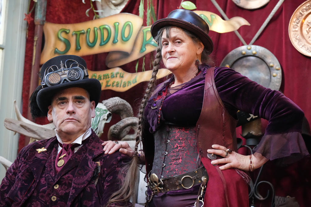 Steampunk NZ Festival attendees Ross McKay and T.S. Taylor, who goes by Miss Purple, pose during the annual event in Ōamaru, New Zealand, Friday, May 29, 2026. (AP Photo/Charlotte Graham-McLay)