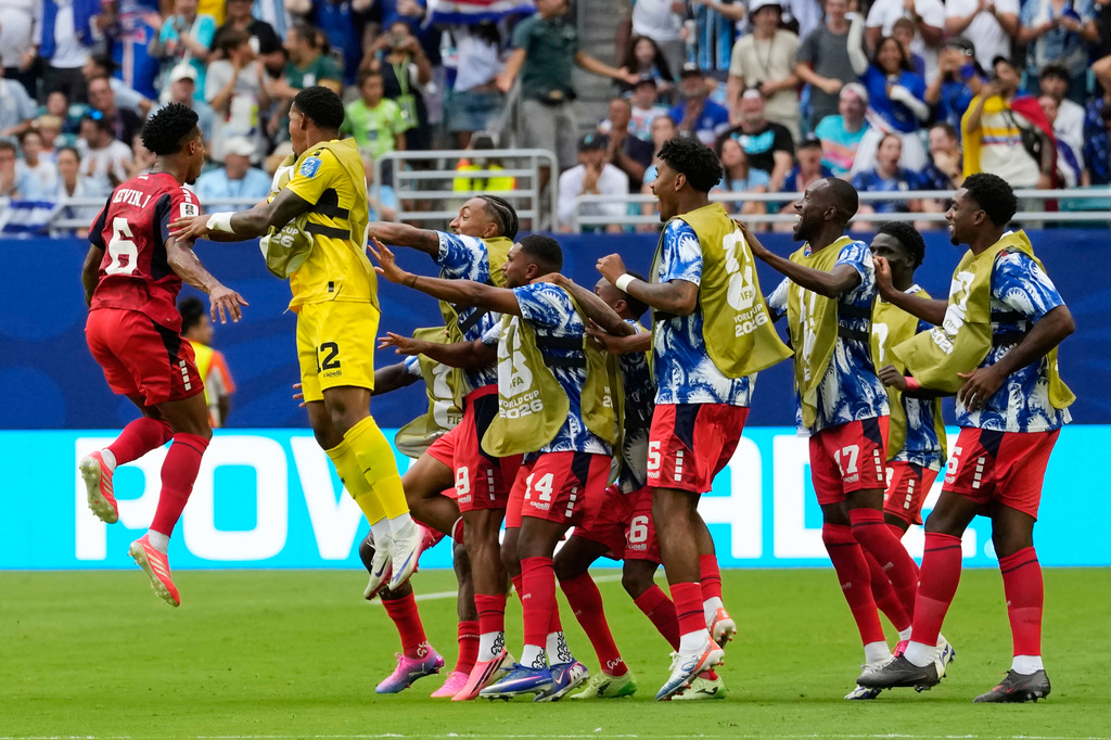 Cape Verde's Kevin Pina, left, celebrates with teammates after scoring his team's first goal during the World Cup Group H soccer match between Uruguay and Cape Verde in Miami Gardens, Fla., Sunday, June 21, 2026. (AP Photo/Rebecca Blackwell)