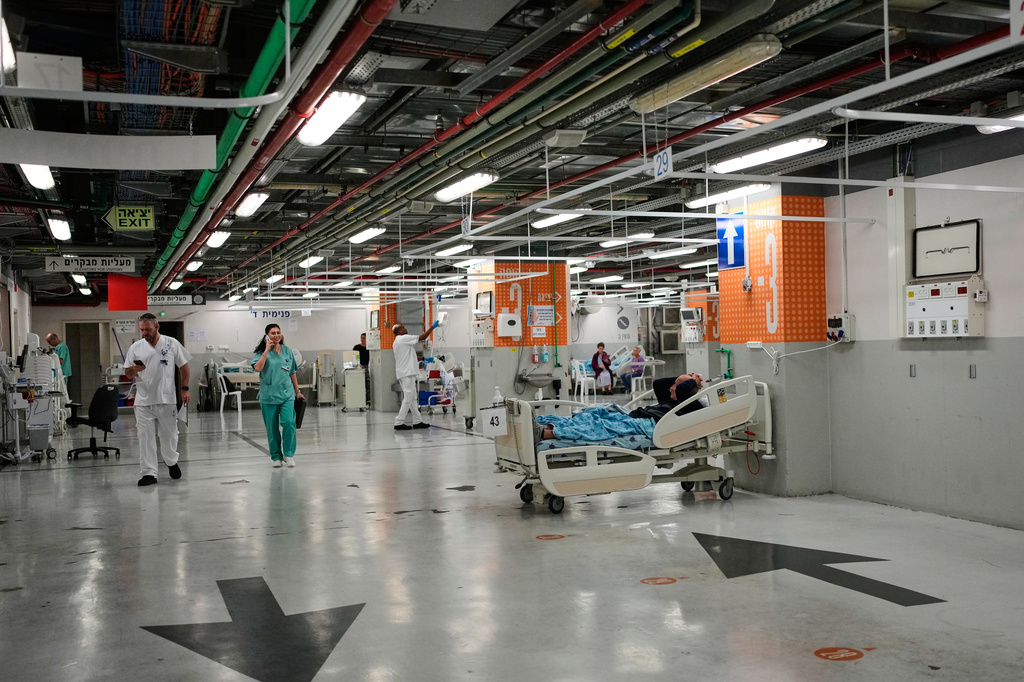 Medical staff transfer patients to a protected underground parking following an Iranian missile attack, at Ichilov Hospital in Tel Aviv, Israel, Monday, June 8, 2026. (AP Photo/Ohad Zwigenberg)