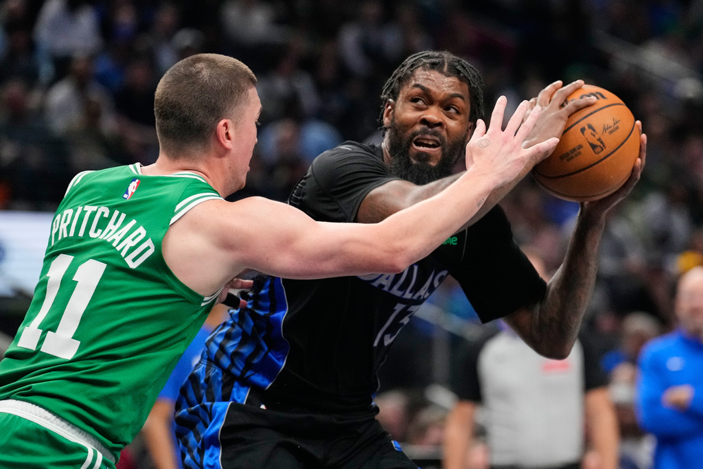 Dallas Mavericks forward Naji Marshall, right, looks for a shot as Boston Celtics' Payton Pritchard (11) defends in the first half of an NBA basketball game Tuesday, Feb. 3, 2026, in Dallas. (AP Photo/Tony Gutierrez)