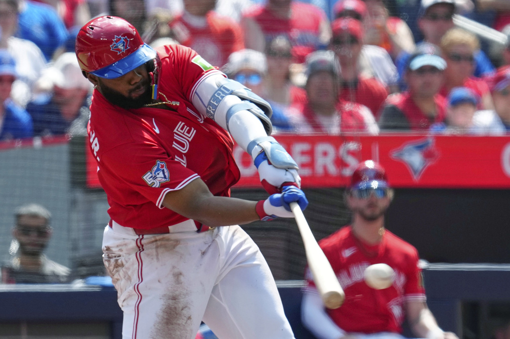Toronto Blue Jays' Vladimir Guerrero Jr. hits a double off of New York Mets pitcher Freddy Peralta during first inning MLB baseball action in Toronto on Wednesday, July 1, 2026. (Frank Gunn/The Canadian Press via AP)