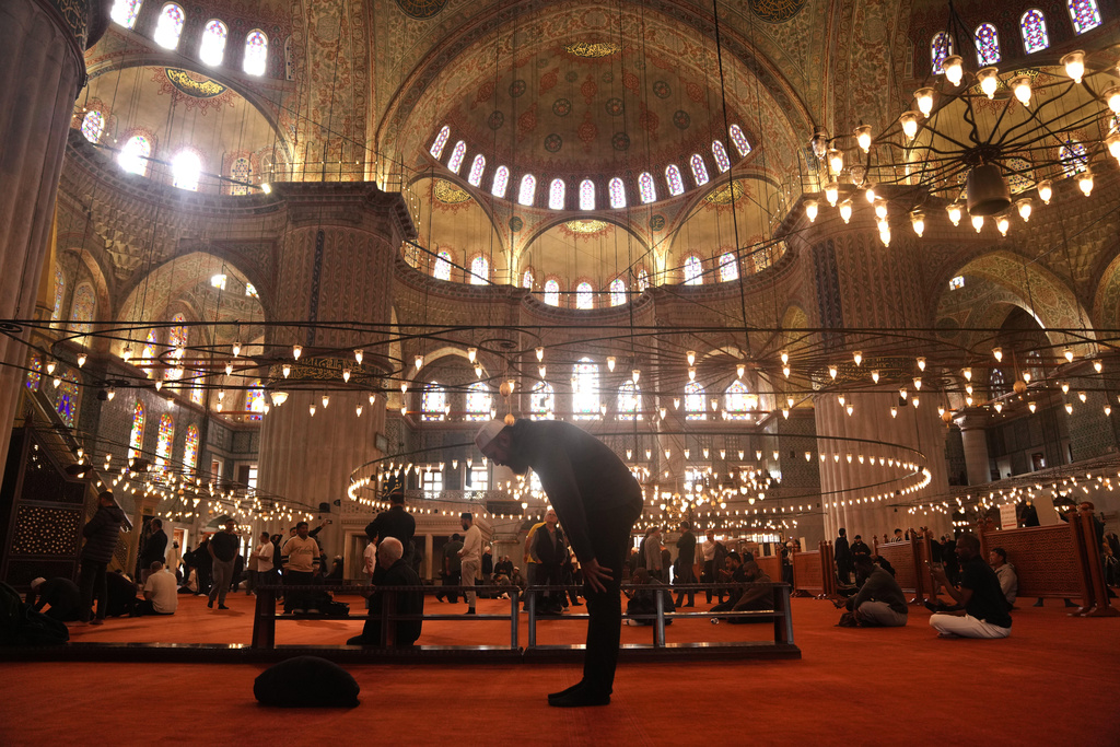 Muslims pray at the Ottoman-era Sultan Ahmed or Blue Mosque, in Istanbul, Turkey, Friday, Nov. 21, 2025, ahead of the visit of Pope Leo XIV to Turkey. (AP Photo/Francisco Seco)