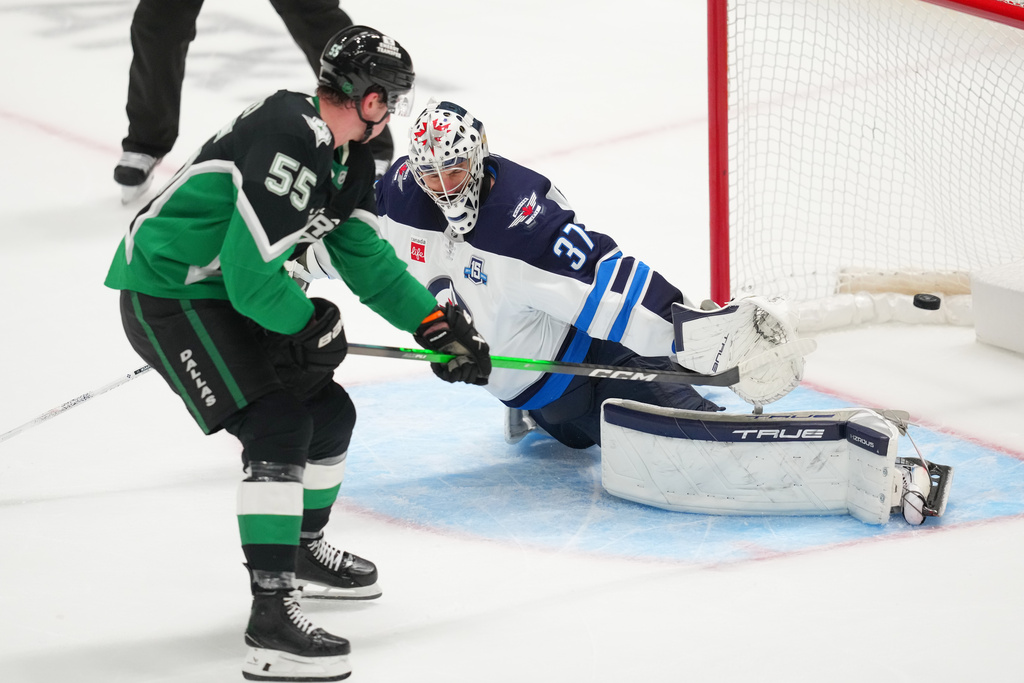 Dallas Stars defenseman Thomas Harley (55) scores the game-winning goal on Winnipeg Jets goaltender Connor Hellebuyck during overtime in an NHL hockey game Monday, Feb. 2, 2026, in Dallas. (AP Photo/Julio Cortez)