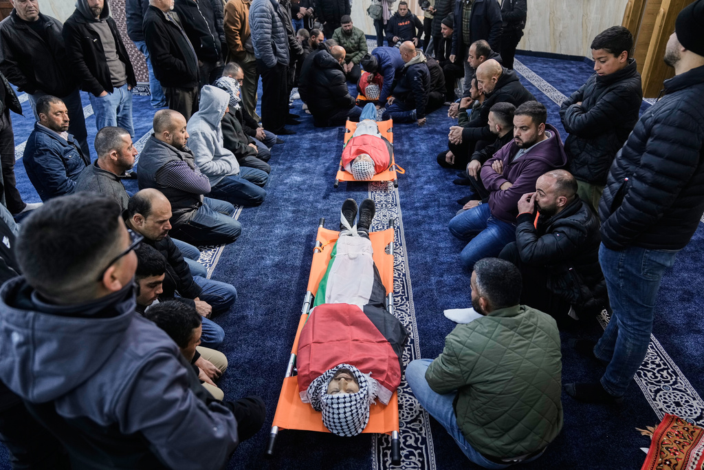 Palestinians mourn Thaer Farouq Hamayel, 24, Farea Hamayel, 57, and Mohammed Marah during their funeral in the West Bank village of Abu Falah, Sunday, March 8, 2026. Thaer Farouq Hamayel, Farea Hamayel were killed in a violent clash with Israeli settlers. (AP Photo/Majdi Mohammed)